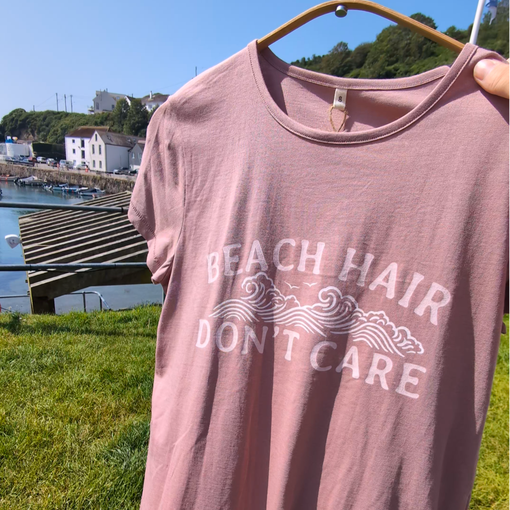 Pink t-shirt with 'Beach Hair Don't Care' slogan.