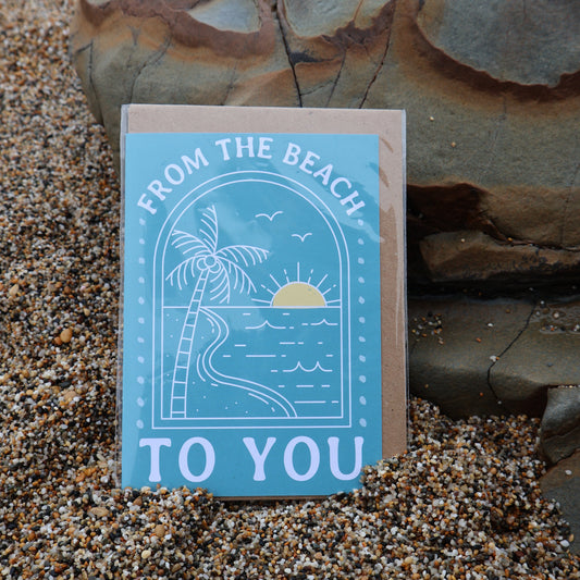 Card with 'From the Beach to You' text and palm tree design on a sandy background