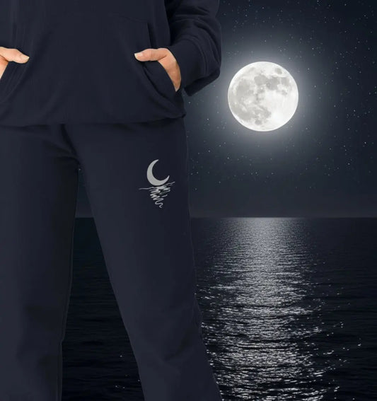 Woman wearing Moonlight Jogging Bottoms organic cotton fleece-lined joggers for cozy nights and outdoor adventures