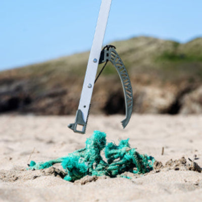 recycled ghost net litter picker picking up nets from a beach 