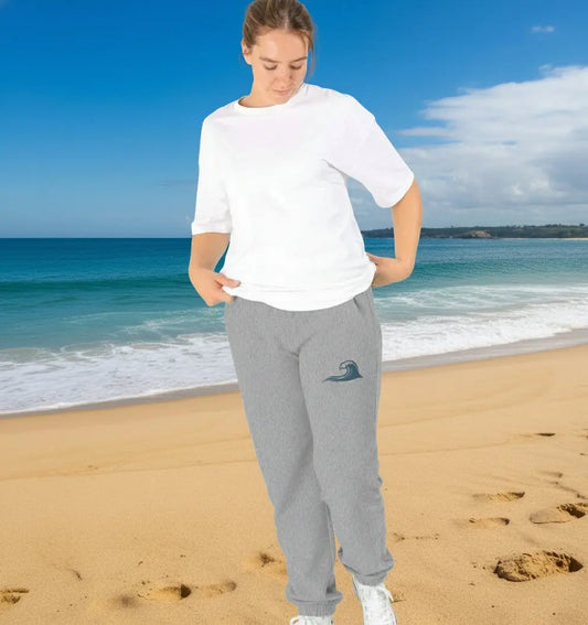 Woman enjoying a coastal adventure in her grey coloured fleece-lined women’s jogging bottoms for comfort and warmth
