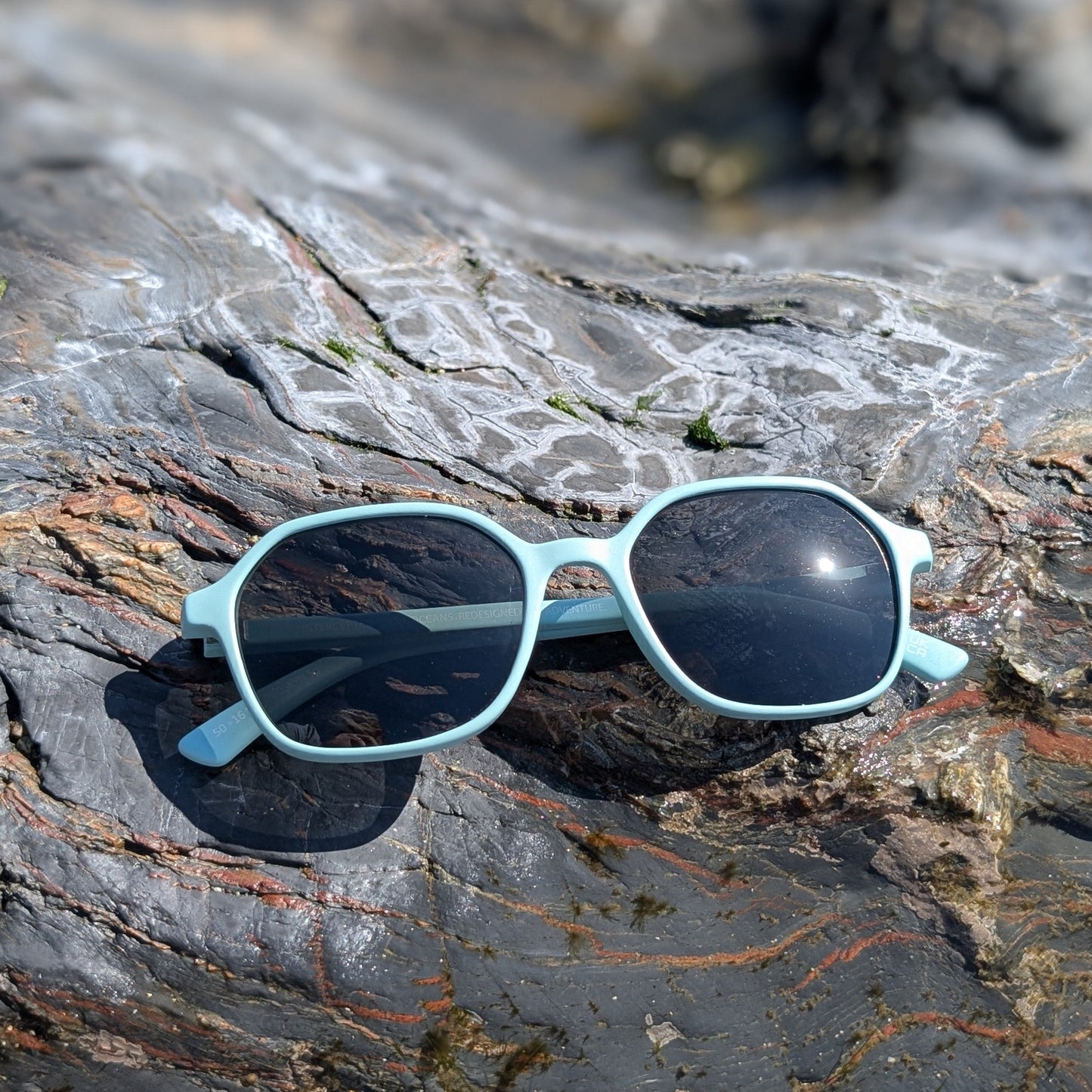 Recycled ocean plastic Sunglasses on a rocky surface with a natural background