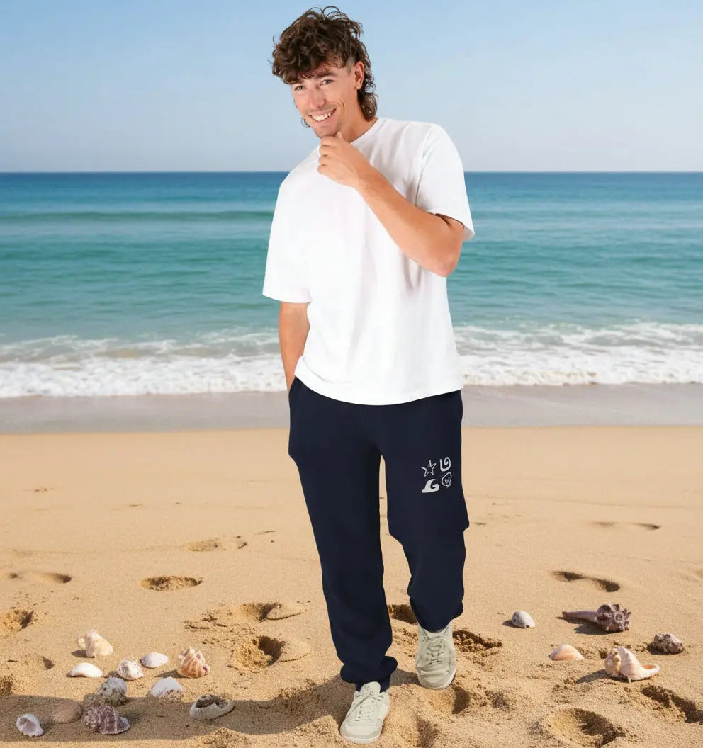 Man wearing Shoreline Jogging Bottoms organic cotton fleece-lined joggers for surf and beach adventures