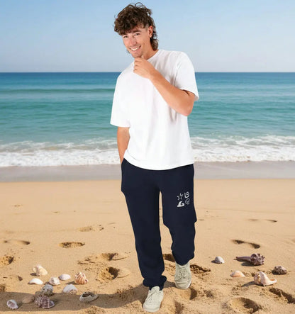 Man wearing Shoreline Jogging Bottoms organic cotton fleece-lined joggers for surf and beach adventures