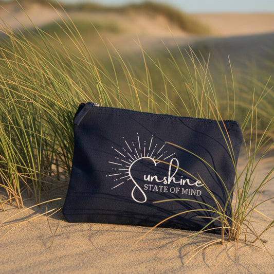 Navy pouch with 'sunshine state of mind' text and sun design on a white background