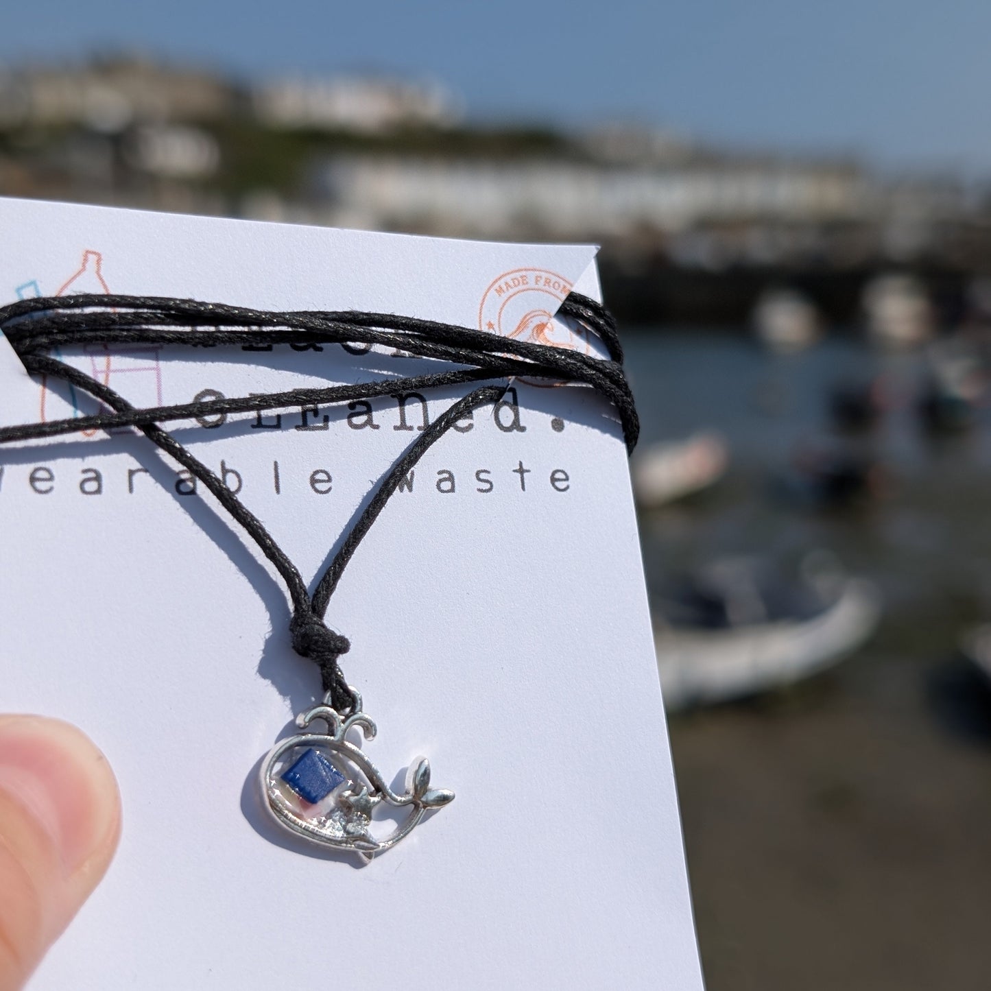 Sustainable silver whale necklace made with beach cleaned plastic set in a bio resin. 