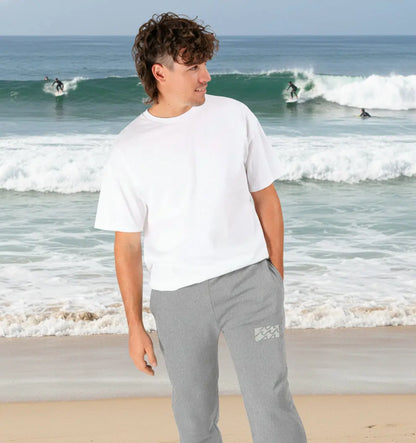 Man wearing Swell Jogging Bottoms organic cotton fleece-lined joggers for surf and beach adventures