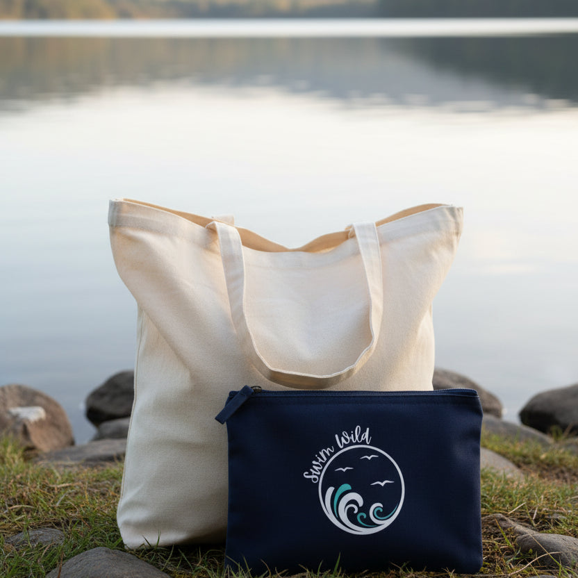 Navy blue pouch with 'Swim Wild' logo featuring waves and birds in front of a wild swimming lake