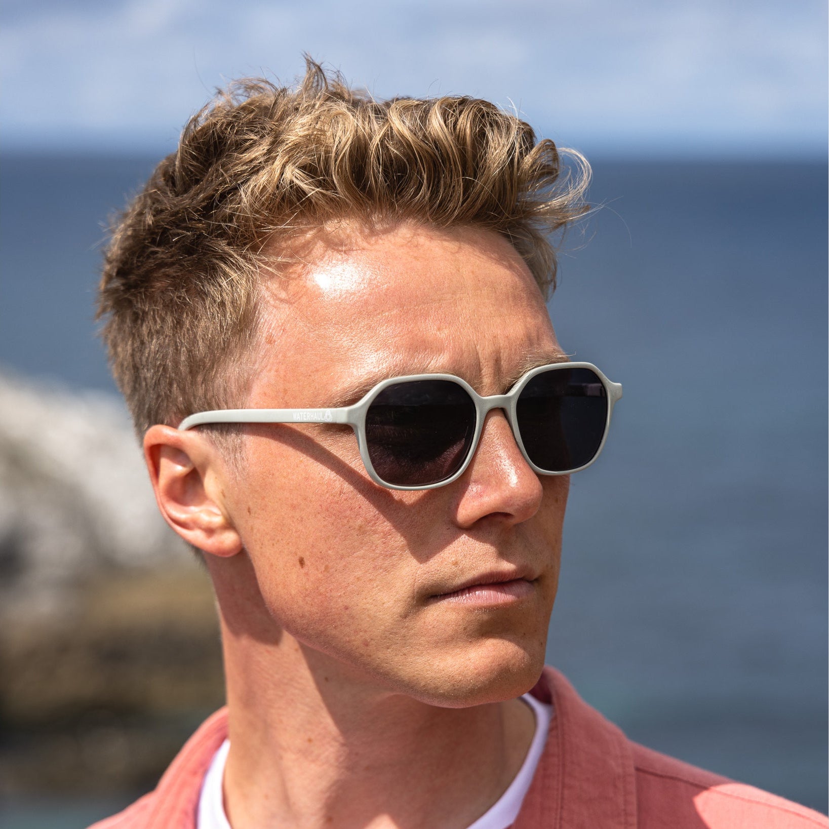 Man wearing sunglasses with a scenic background