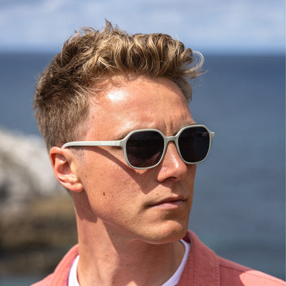 Man wearing sunglasses with a scenic background