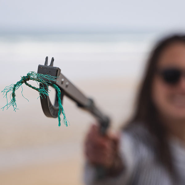 close up of ghost net being picked up by a recycled ocean plastic litter picker 
