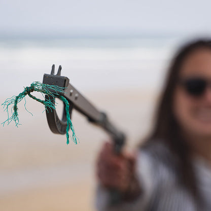 close up of ghost net being picked up by a recycled ocean plastic litter picker 