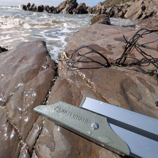 close up of the folding section on the recycled plastic litter picker featuring the waterhaul logo 
